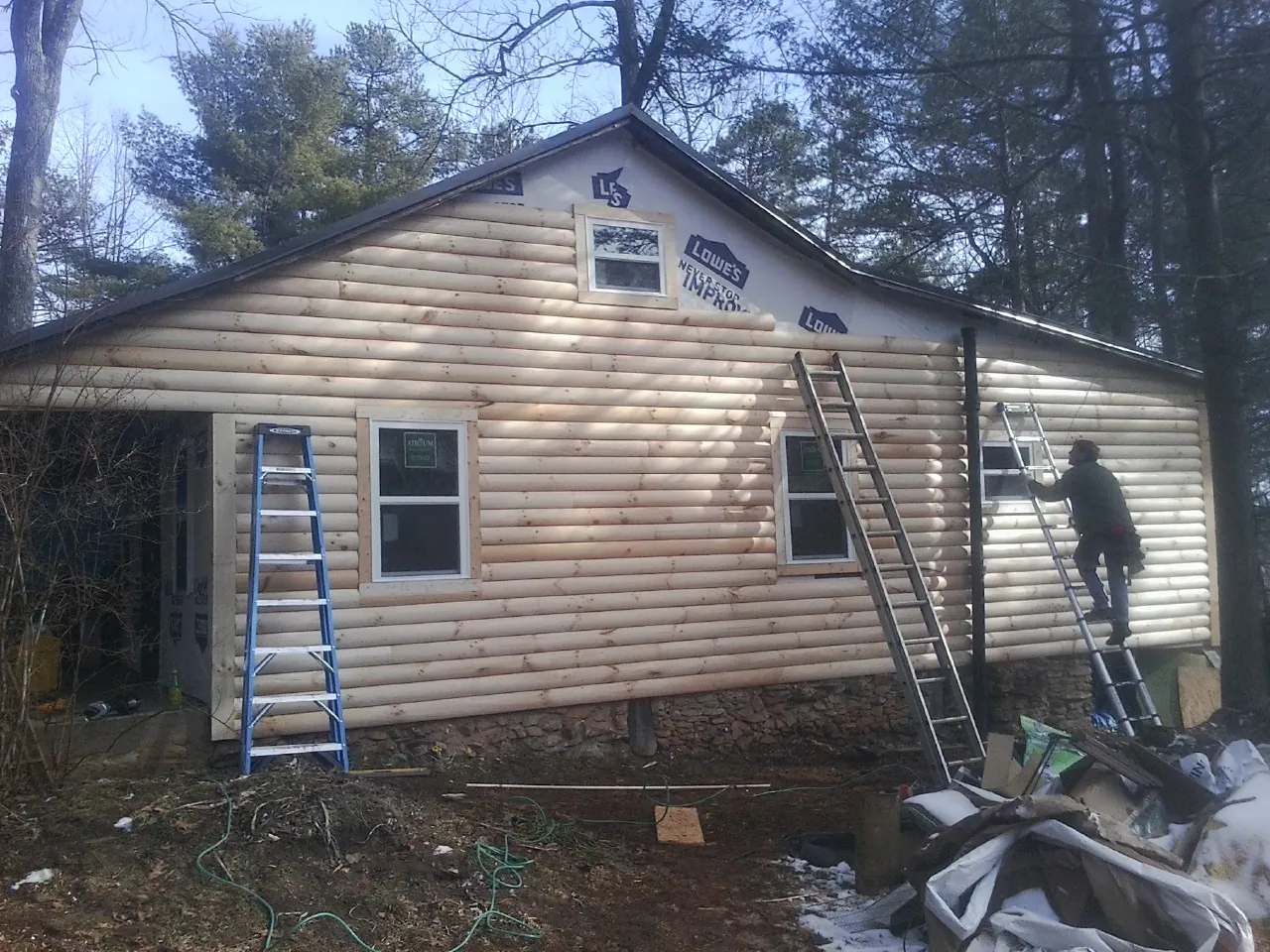 Ladders set against fresh log siding during an exterior remodel in American Canyon