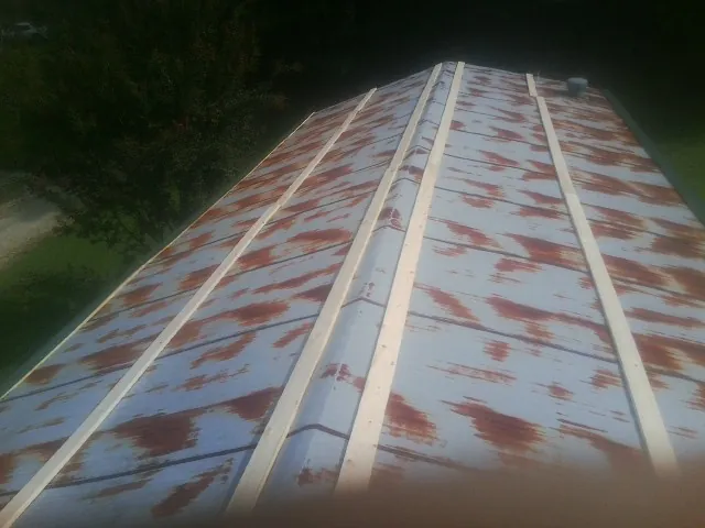Rusted metal roof panels with new wood purlins before replacement — Storm Damage Roof Repair in American Canyon by Roofing Brothers