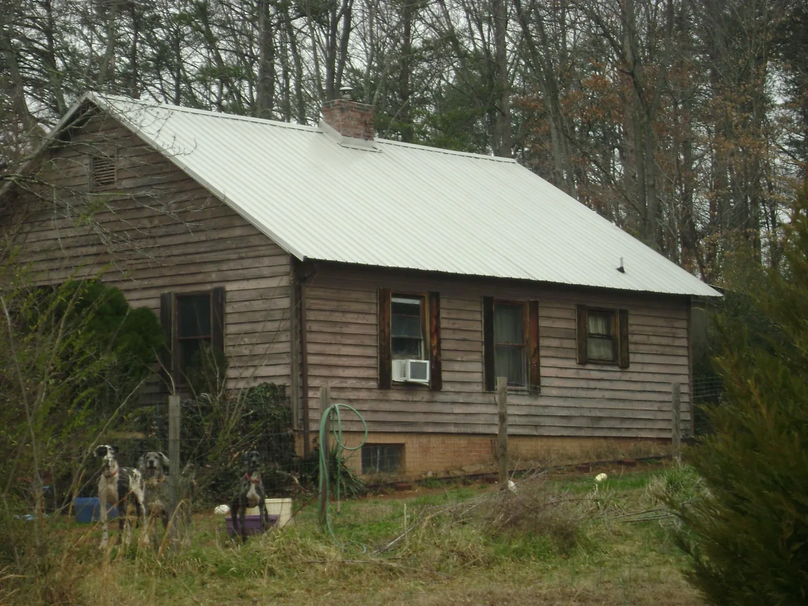 White metal roof on an old wood sided farmhouse, from a Metal Roof Installation job in American Canyon
